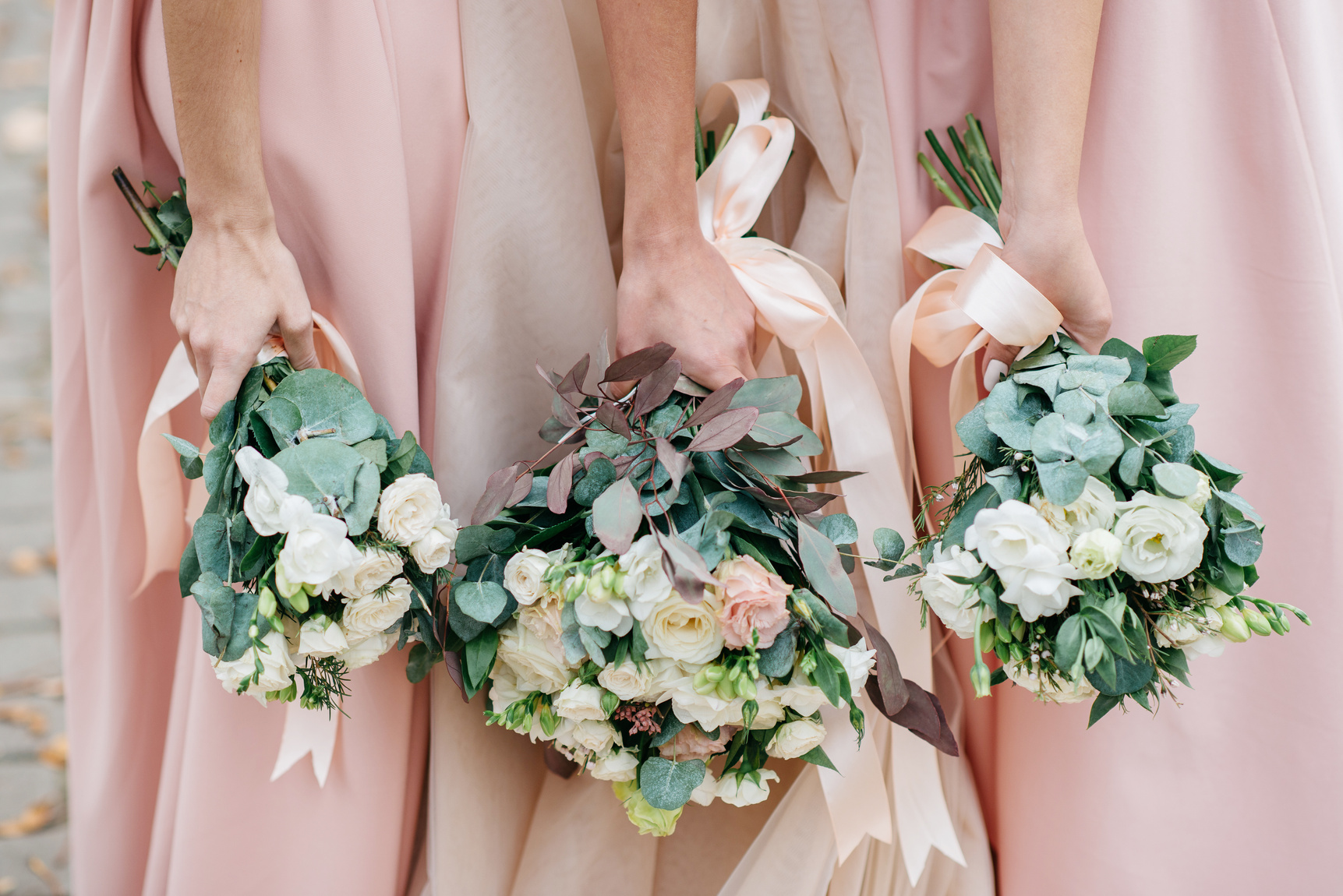 Wedding flowers in hand the bride and her bridesmaids.